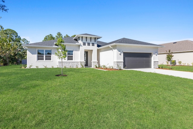 prairie-style home with a garage and a front yard