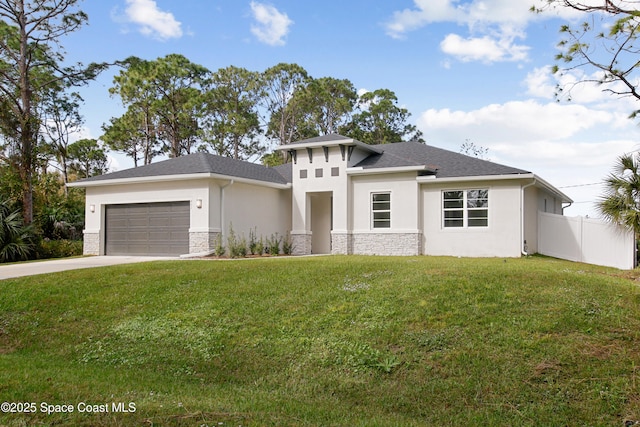 prairie-style home featuring fence, stucco siding, a front lawn, a garage, and stone siding