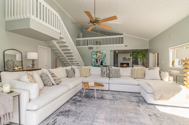 living room featuring ceiling fan, wood ceiling, and high vaulted ceiling