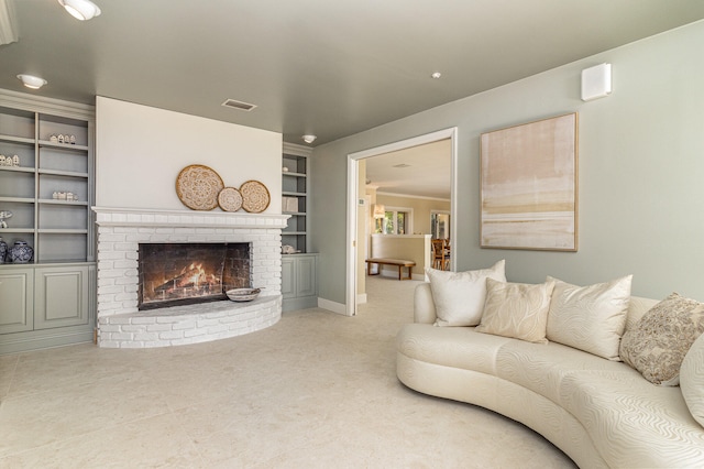 living room featuring built in shelves and a fireplace