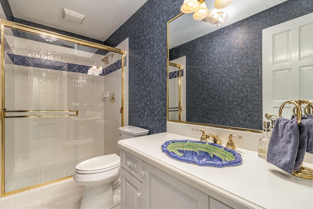 bathroom featuring toilet, tile patterned floors, walk in shower, and vanity