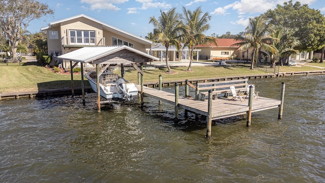 dock area featuring a balcony, a yard, and a water view