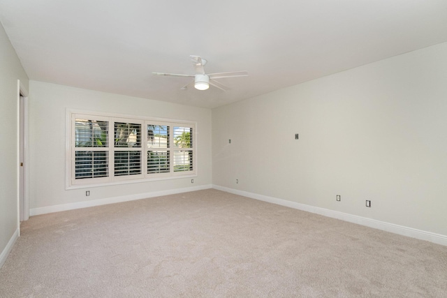 unfurnished room featuring ceiling fan and light colored carpet