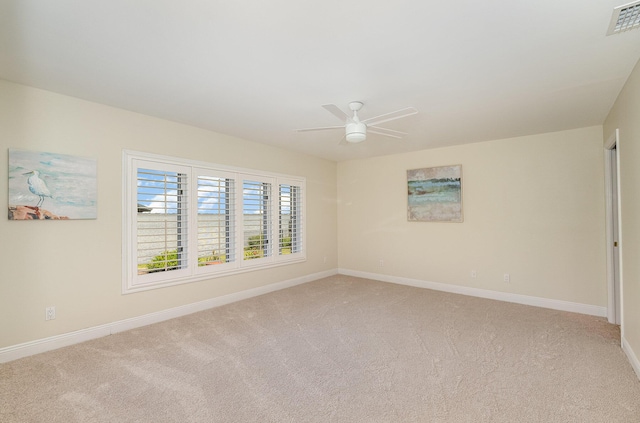 unfurnished room featuring ceiling fan and light carpet