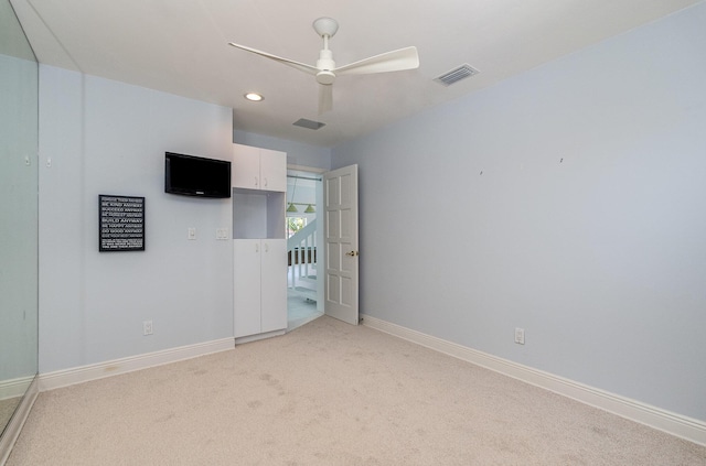 unfurnished bedroom featuring ceiling fan and light carpet