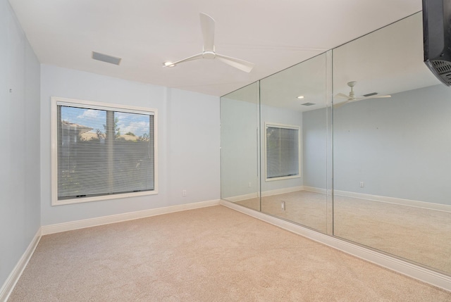 unfurnished bedroom featuring ceiling fan, carpet flooring, and a closet