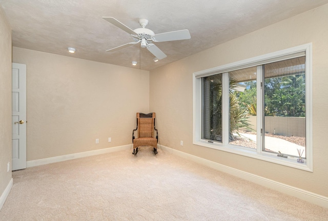 unfurnished room with carpet floors, ceiling fan, and a textured ceiling