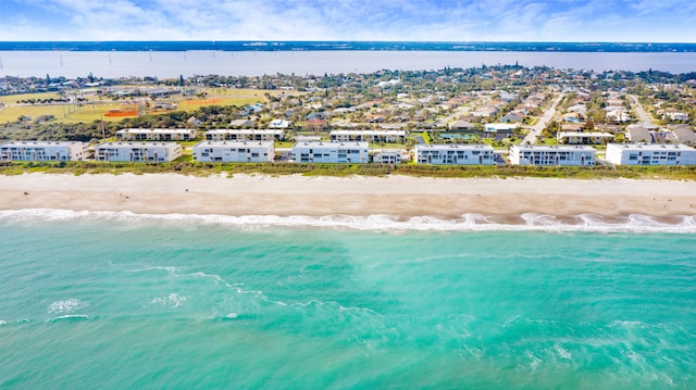 bird's eye view featuring a view of the beach and a water view