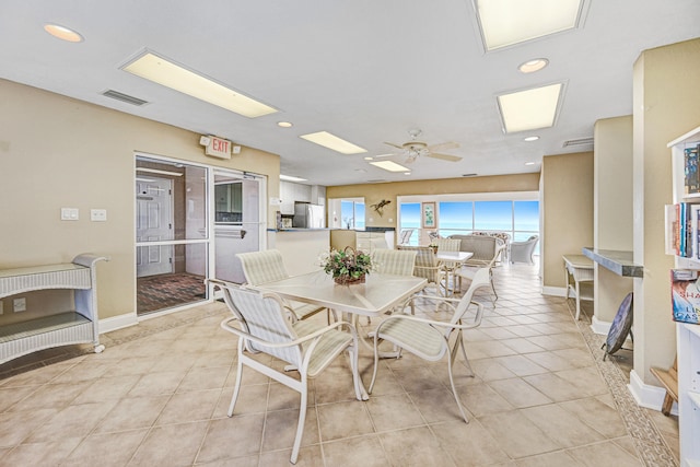 dining area featuring ceiling fan and light tile patterned floors