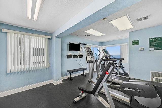 exercise area featuring a textured ceiling