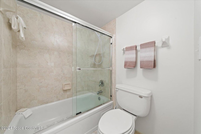 bathroom featuring toilet and enclosed tub / shower combo