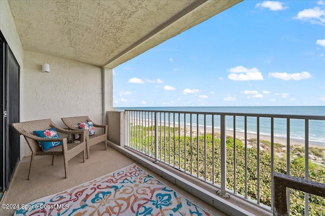 balcony featuring a water view and a view of the beach