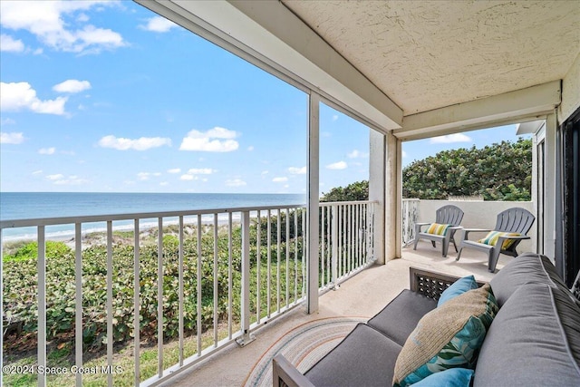 balcony with a view of the beach and a water view