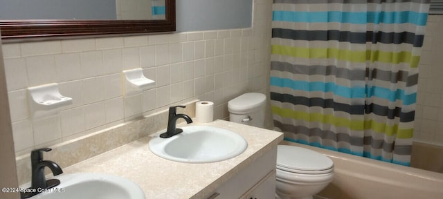 full bathroom with vanity, shower / bathtub combination with curtain, tile walls, and toilet