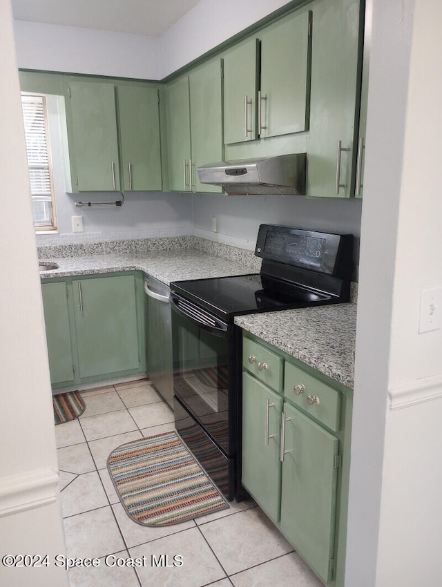 kitchen featuring black range with electric stovetop, green cabinets, light tile patterned floors, and ventilation hood