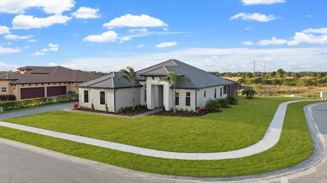 view of front of house with a front yard and a garage