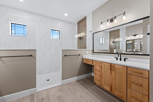 bathroom featuring a wealth of natural light, vanity, and hardwood / wood-style flooring