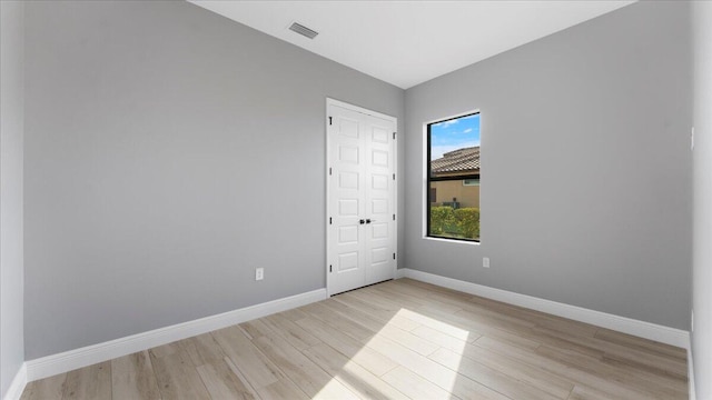 spare room with light wood-type flooring