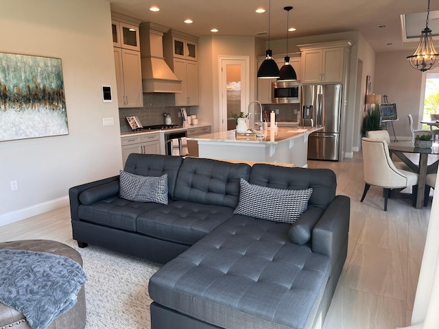 living room featuring light hardwood / wood-style floors, sink, and a chandelier