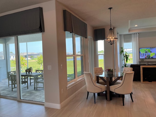 dining room with a notable chandelier and plenty of natural light