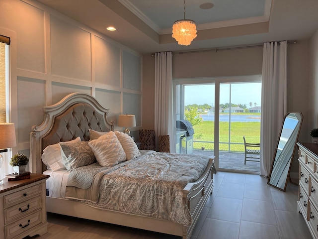 tiled bedroom with access to outside, a tray ceiling, an inviting chandelier, and ornamental molding