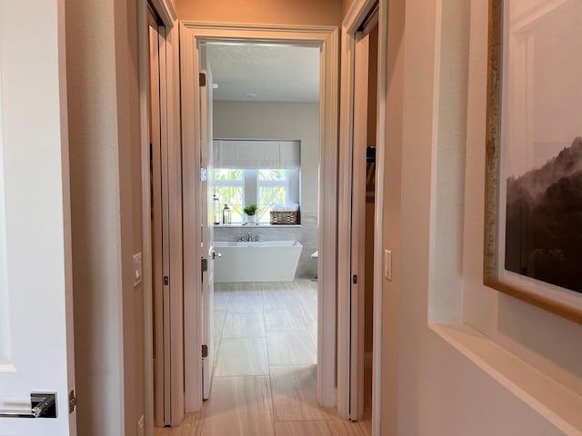 hallway with a textured ceiling