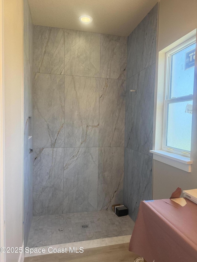full bathroom featuring tiled shower
