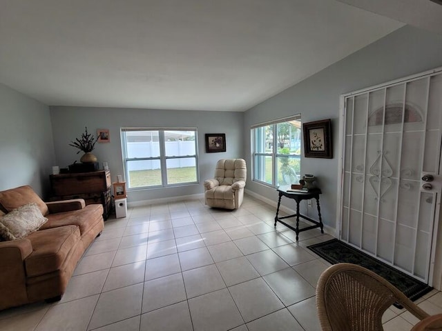 living room featuring light tile flooring and vaulted ceiling