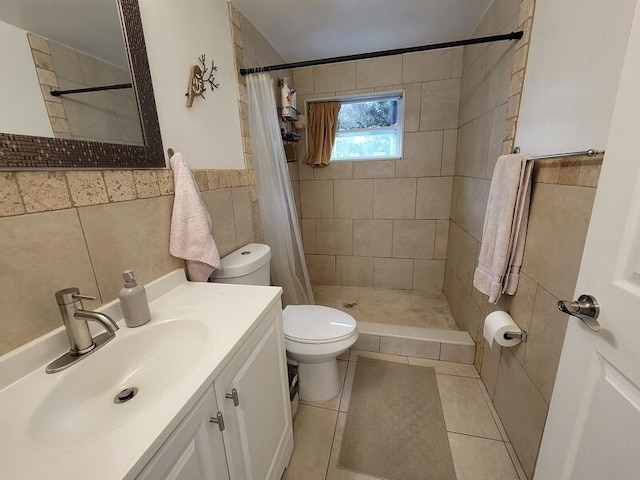 bathroom with tile walls, tile flooring, a shower with curtain, toilet, and large vanity