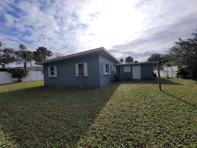 rear view of property with a lawn