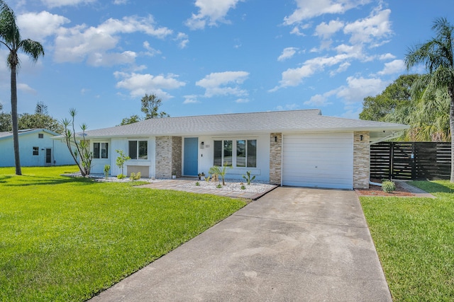 single story home featuring a garage and a front lawn