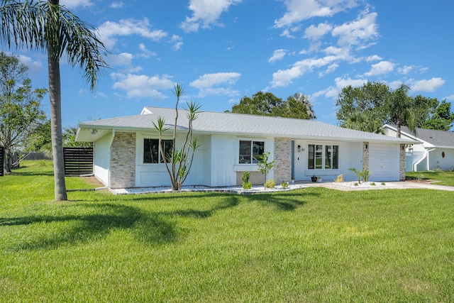 single story home featuring a garage and a front yard