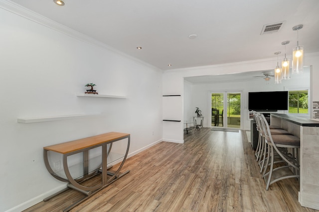 interior space featuring hardwood / wood-style floors, a notable chandelier, and ornamental molding