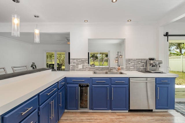 kitchen featuring backsplash, sink, ceiling fan, and stainless steel dishwasher