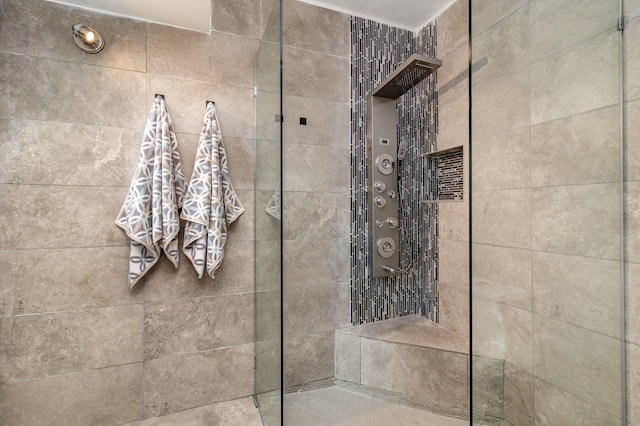 bathroom featuring a shower with door