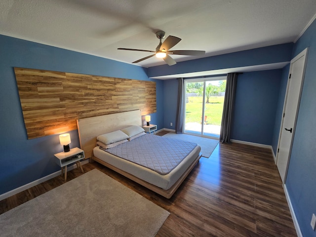 unfurnished bedroom featuring dark hardwood / wood-style flooring, ceiling fan, access to outside, and a textured ceiling