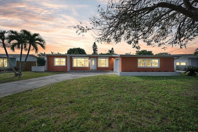 ranch-style home with a lawn