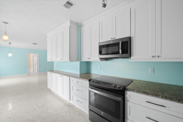 kitchen featuring hanging light fixtures, stainless steel appliances, white cabinets, and dark stone counters