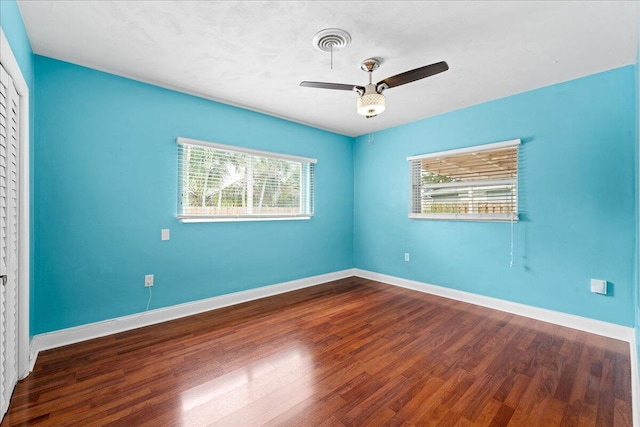 unfurnished room featuring ceiling fan and dark hardwood / wood-style floors