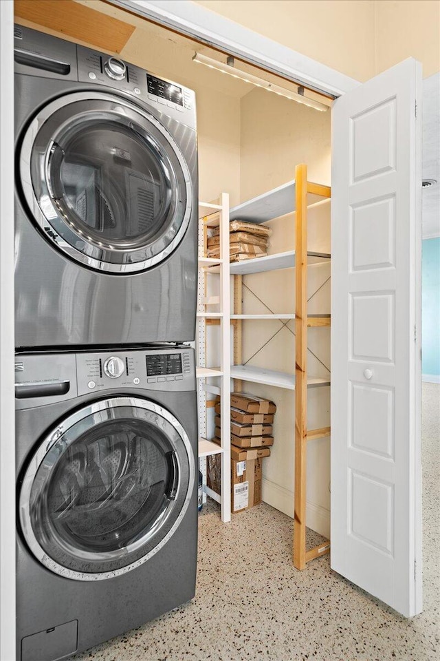 laundry room featuring stacked washer and dryer