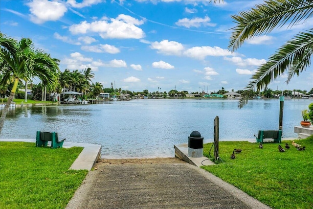 dock area featuring a water view and a yard