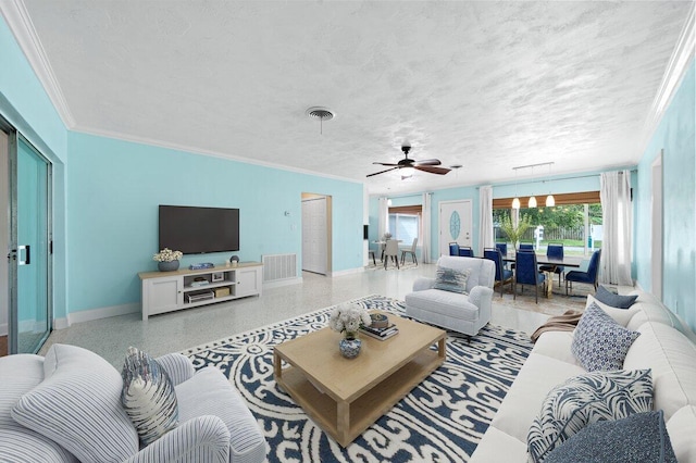 living room featuring ornamental molding, a textured ceiling, and ceiling fan