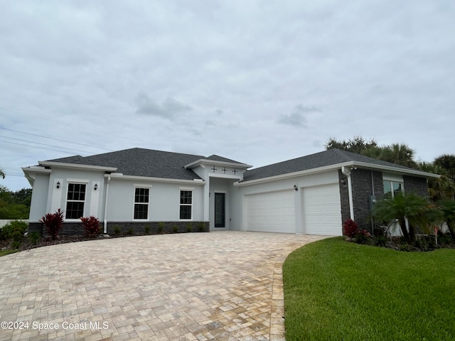 view of front facade with a front yard and a garage