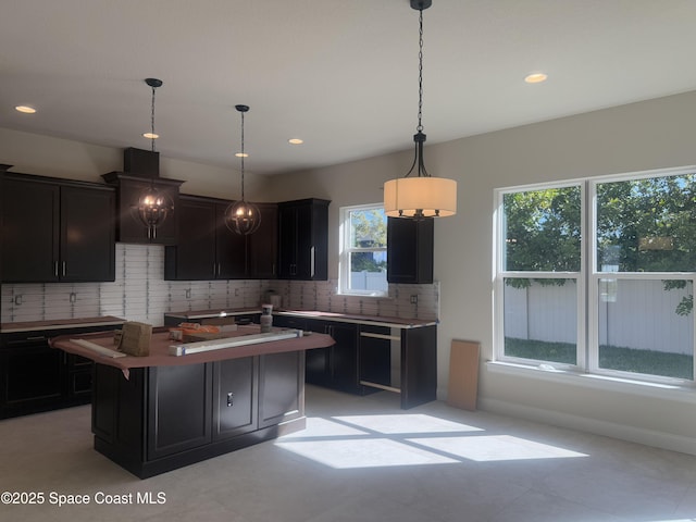 kitchen featuring a kitchen island, pendant lighting, backsplash, and recessed lighting