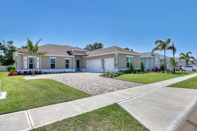 4335 Negal Cir, Melbourne, FL 32901 - single story home featuring a garage, decorative driveway, stucco siding, and a front lawn