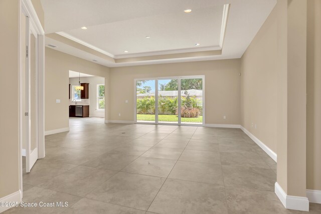 4335 Negal Cir, Melbourne, FL 32901 - spare room featuring a tray ceiling, baseboards, light tile patterned floors, and recessed lighting