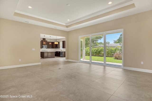 4335 Negal Cir, Melbourne, FL 32901 - unfurnished living room featuring a raised ceiling, baseboards, light tile patterned flooring, and recessed lighting