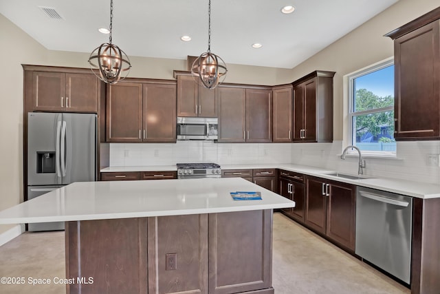 4335 Negal Cir, Melbourne, FL 32901 - kitchen featuring appliances with stainless steel finishes, a chandelier, backsplash, light countertops, and a sink