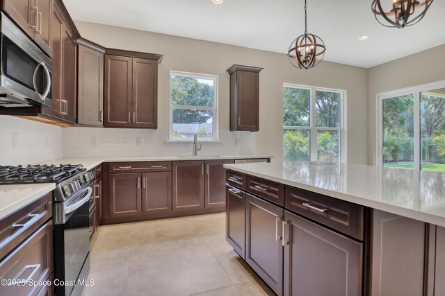 4335 Negal Cir, Melbourne, FL 32901 - kitchen featuring appliances with stainless steel finishes, a chandelier, a sink, plenty of natural light, and recessed lighting