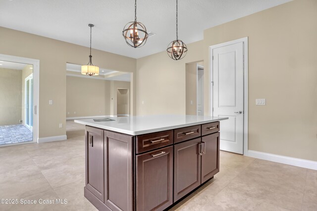 4335 Negal Cir, Melbourne, FL 32901 - kitchen featuring a chandelier, light countertops, decorative light fixtures, baseboards, and light tile patterned flooring